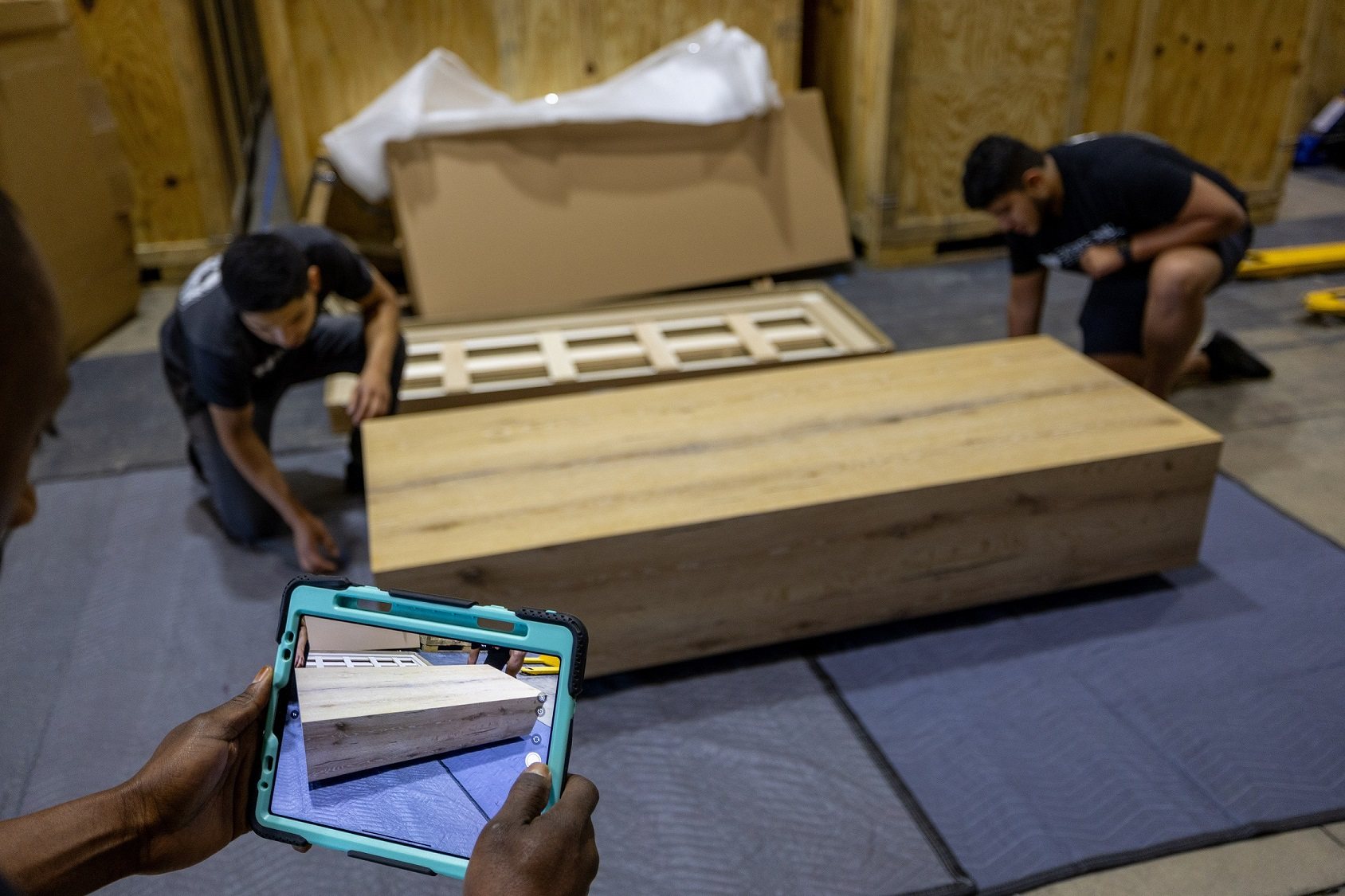 Double Diamond crew documenting a received furniture item for an interior design project