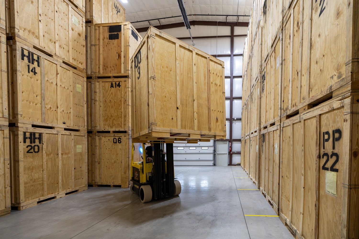 Forklift moving vault storage containers inside a Double Diamond warehouse
